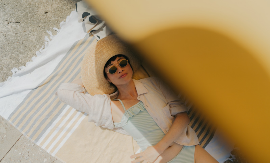 women on beach with sun protection