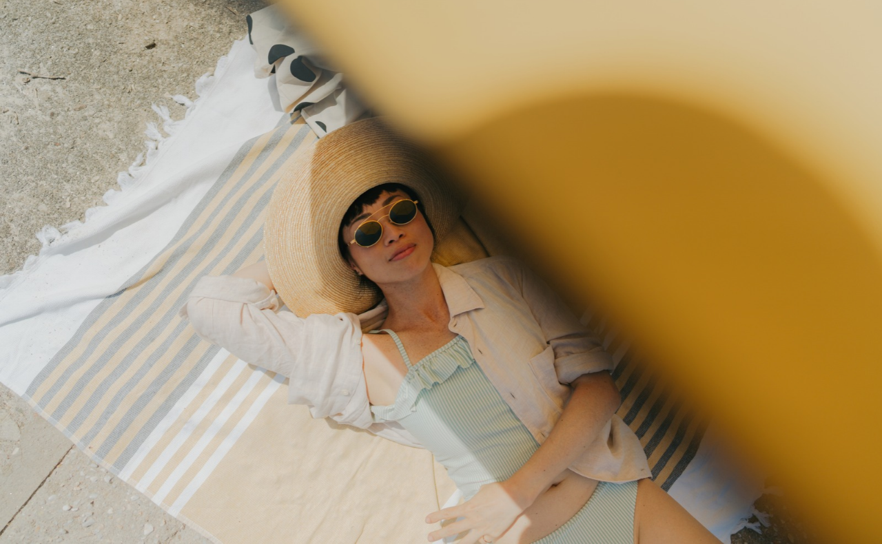 women on beach with sun protection
